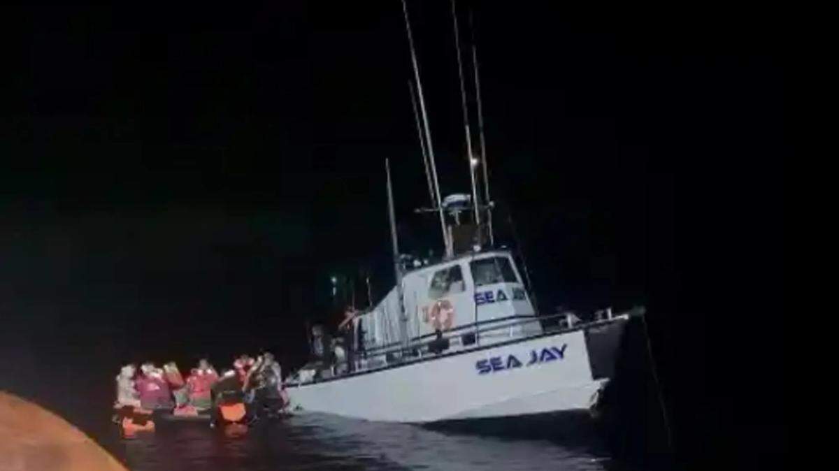 Passengers and crew of the sinking vessel Sea Jay climb into a deployed life raft as a Good Samaritan vessel, the Sea Biscuit, arrives to assist them on Thursday, June 15, 2023. The Sea Biscuit responded swiftly to a distress call and assisted in the rescue operation.