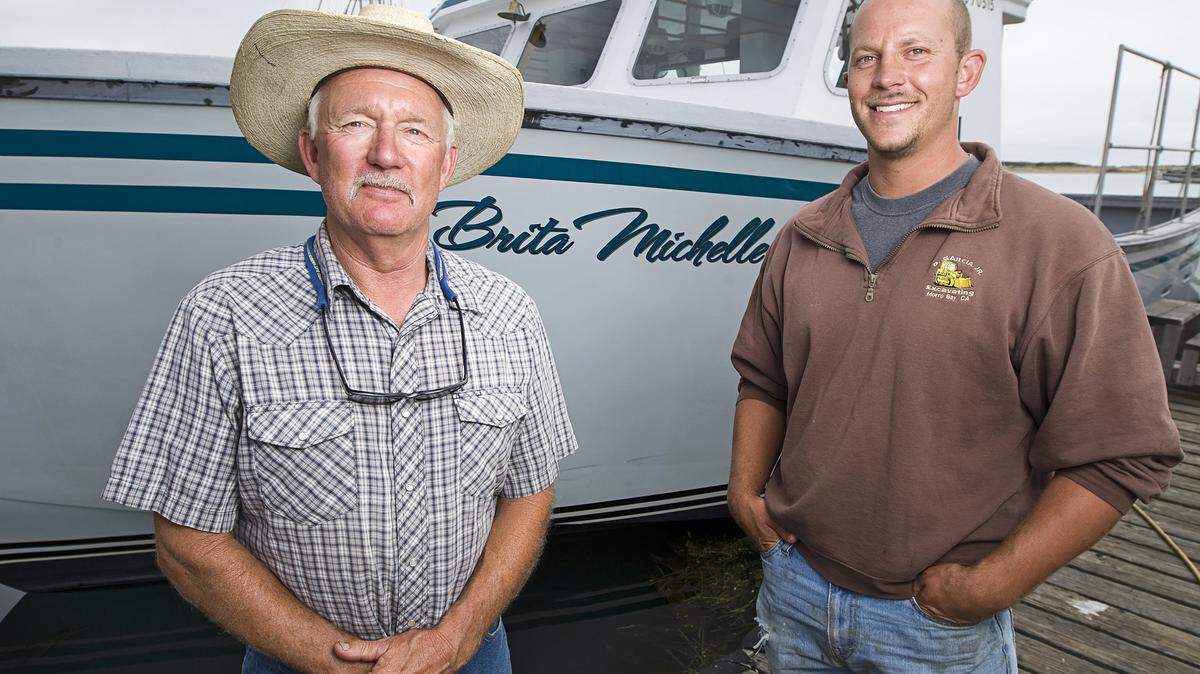 Bill Blue, left, and his son, Scott, standing with their boat the Brita Michelle, are fishermen in Morro Bay.