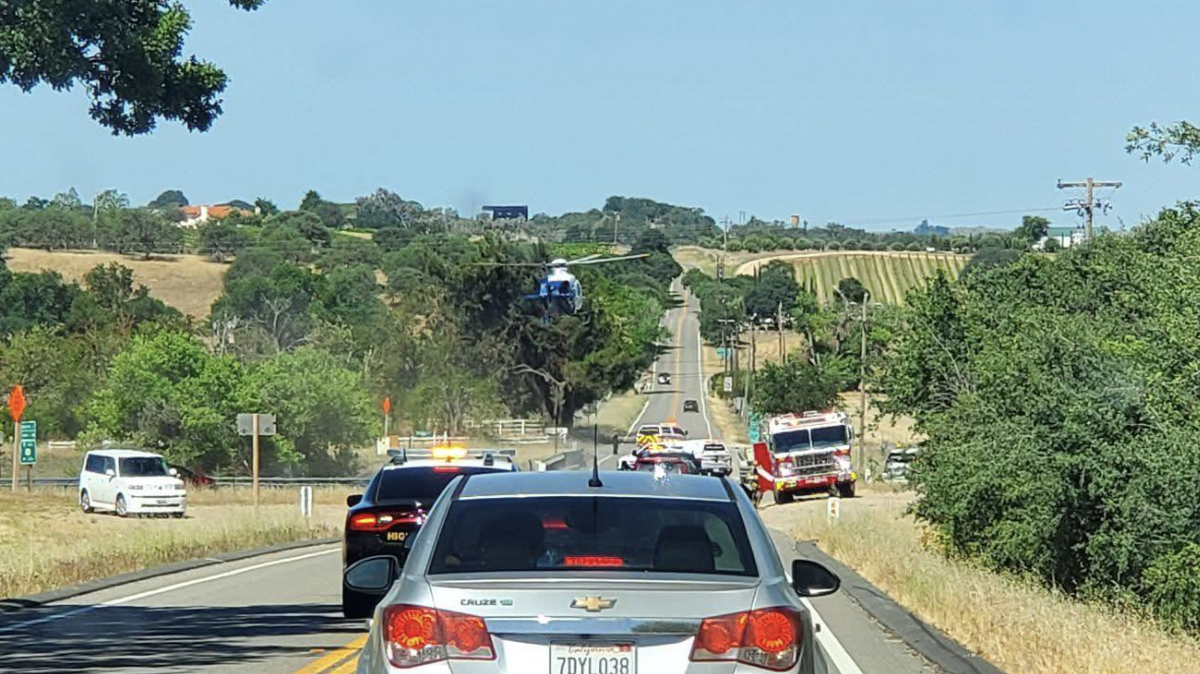 A helicopter is landing on Highway 41 for medevac for the passengers, two of which have major injuries.
