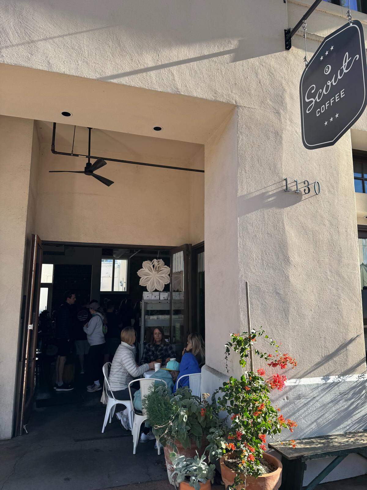 Customers navigate a darkened Scout Coffee in downtown San Luis Obispo during a power outage on Saturday, Dec. 27, 2025.