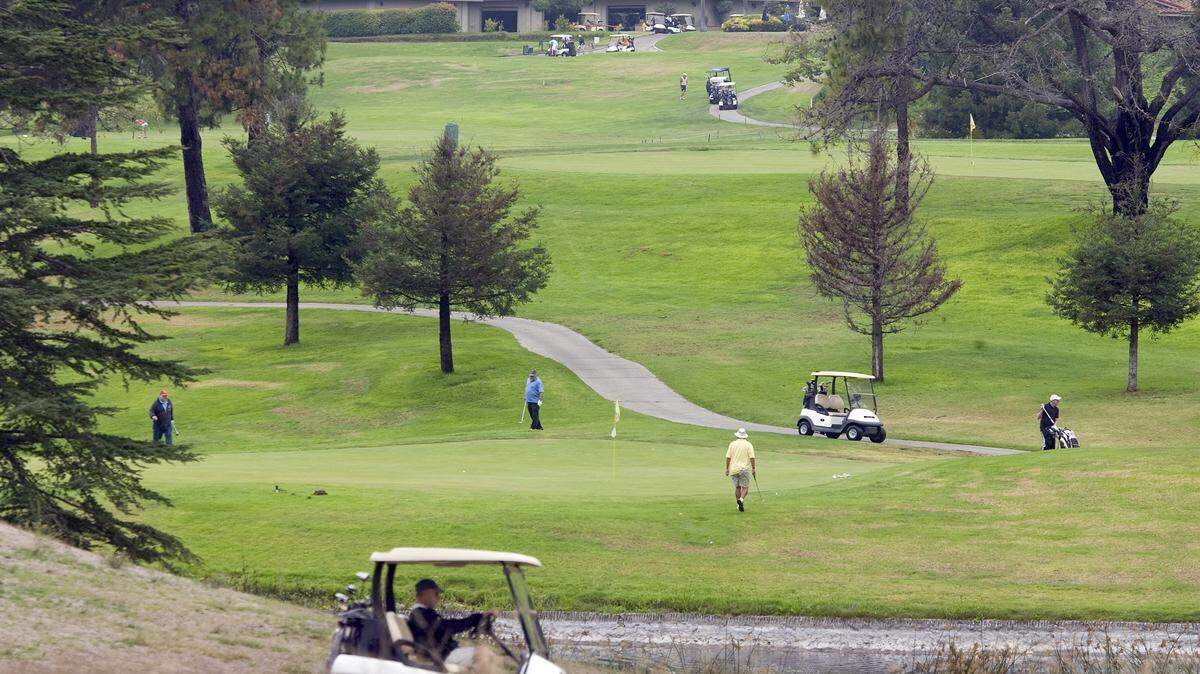 Owner and developer Rob Rossi is proposing to build about 100 single-family homes, a 130-room hotel and about 50 retirement units on the Blacklake Golf Resort property. Above, golfers on Friday.