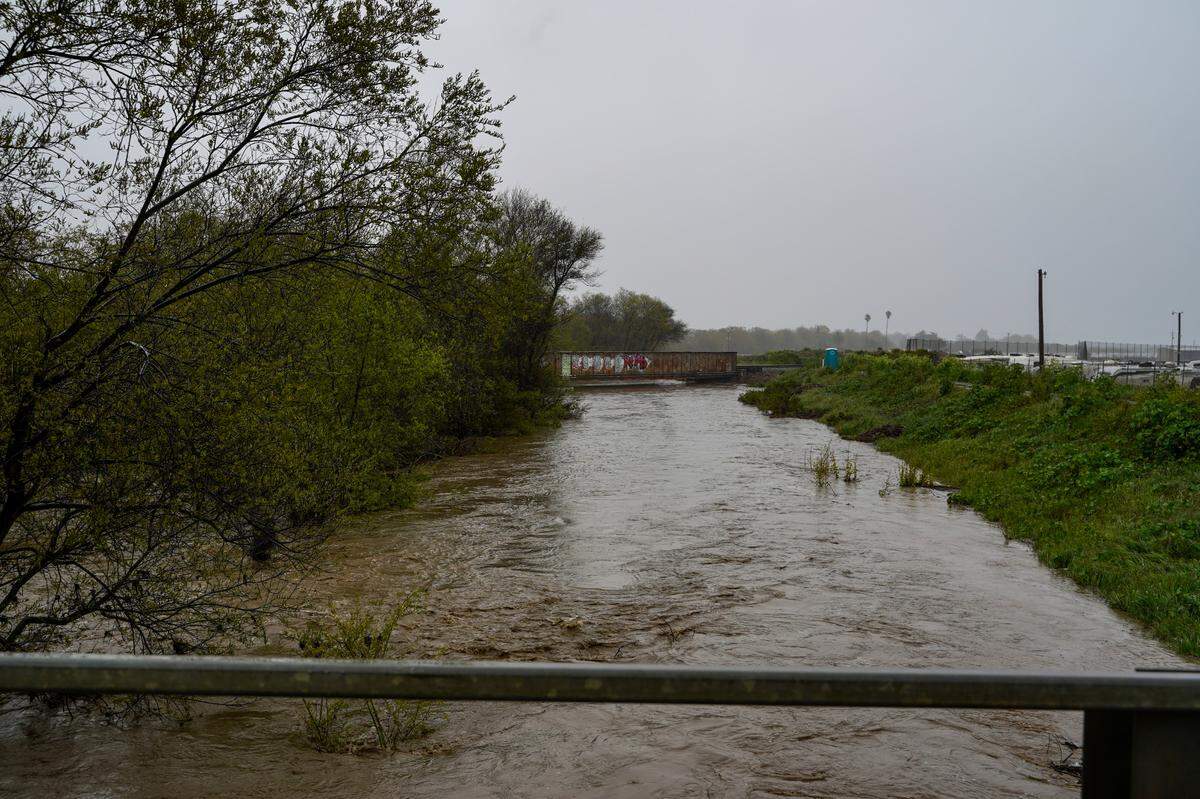 San Luis Obispo County Department of Public Works officials monitor the Arroyo Grande Creek levee’s overflow levels on March 10, 2023.