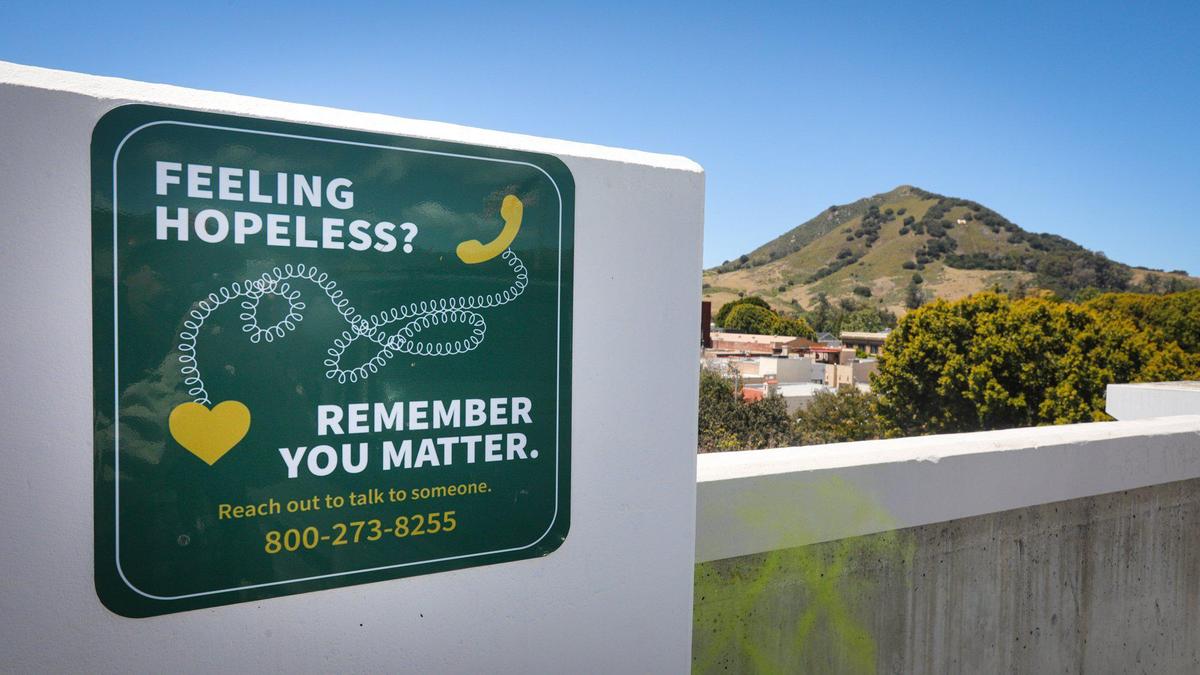Signs are posted on parking structures in San Luis Obispo offering help for depression May 10, 2022; Thomas Jodry died in a fall from the thirdl level of Marsh Street structure.