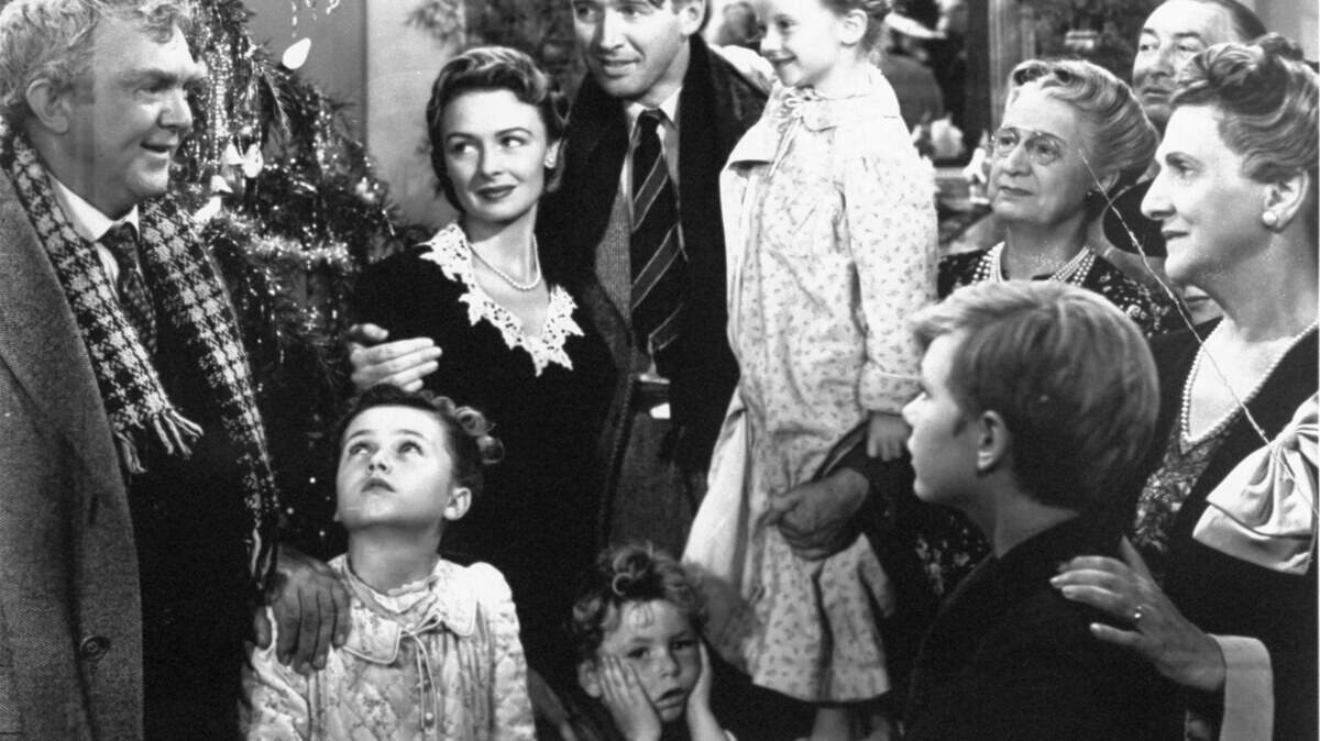 George Bailey (James Stewart), center, is reunited with his wife, Mary (Donna Reed), left, and children during the last scene of Frank Capra's "It's A Wonderful Life".