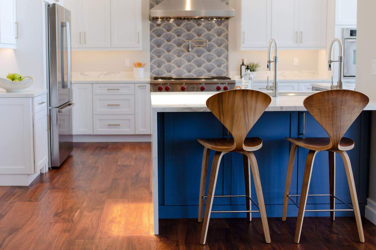 A countertop with a waterfall edge offers extra seating in the remodeled kitchen of Jovita and Alex Honor’s Arroyo Grande house.