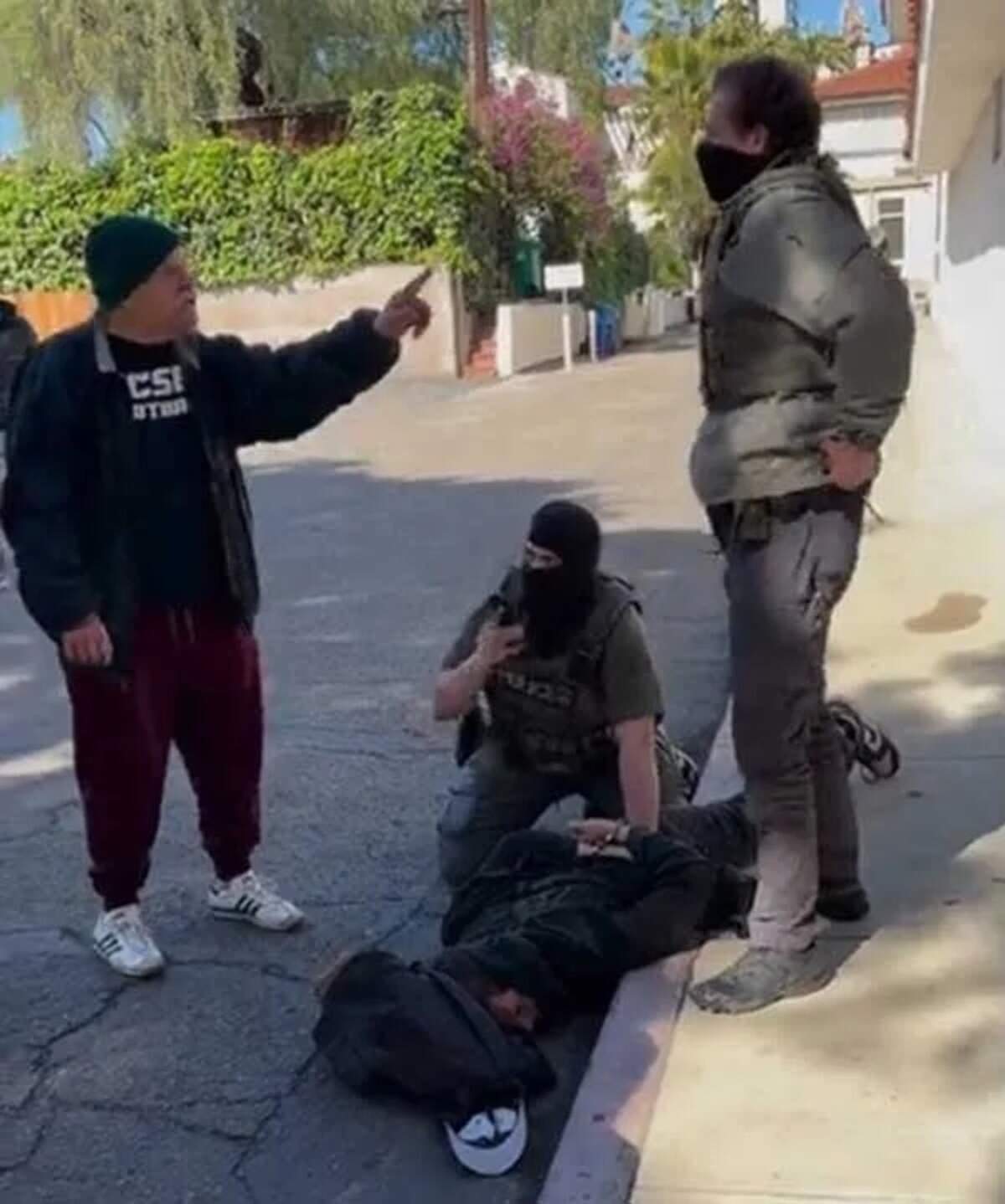 Doug Hayes, left, approaches and verbally confronts ICE agents who were pinning down Santa Barbara man Jake Randmaa and had him in a headlock as they handcuffed him on Friday morning, Feb. 20, 2026. They alleged the man had vandalized one of their vehicles in downtown Santa Barbara.