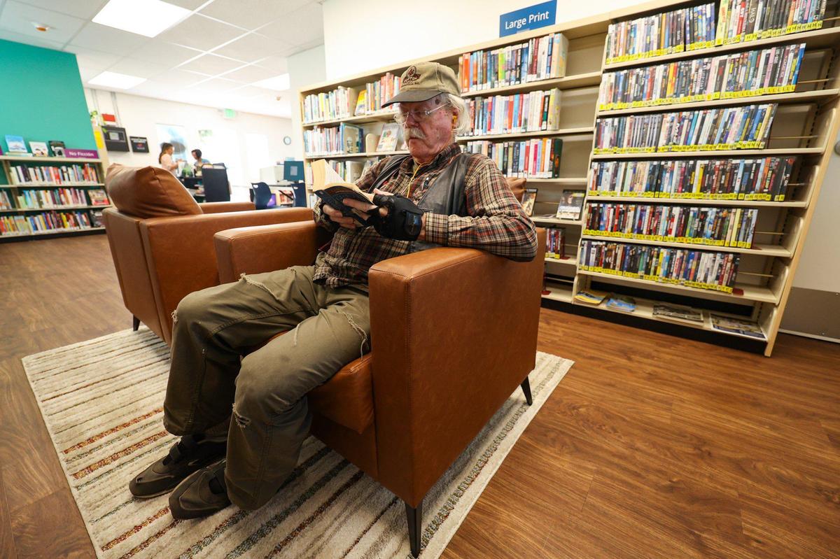 Jake Jardine reads “Game of Thrones” and behind him is a section of large print books. Though the branch is small, resources can be ordered from the county’s system. Oceano has a new library near the community center and elementary school on 19th Street seen here Oct. 4, 2023.