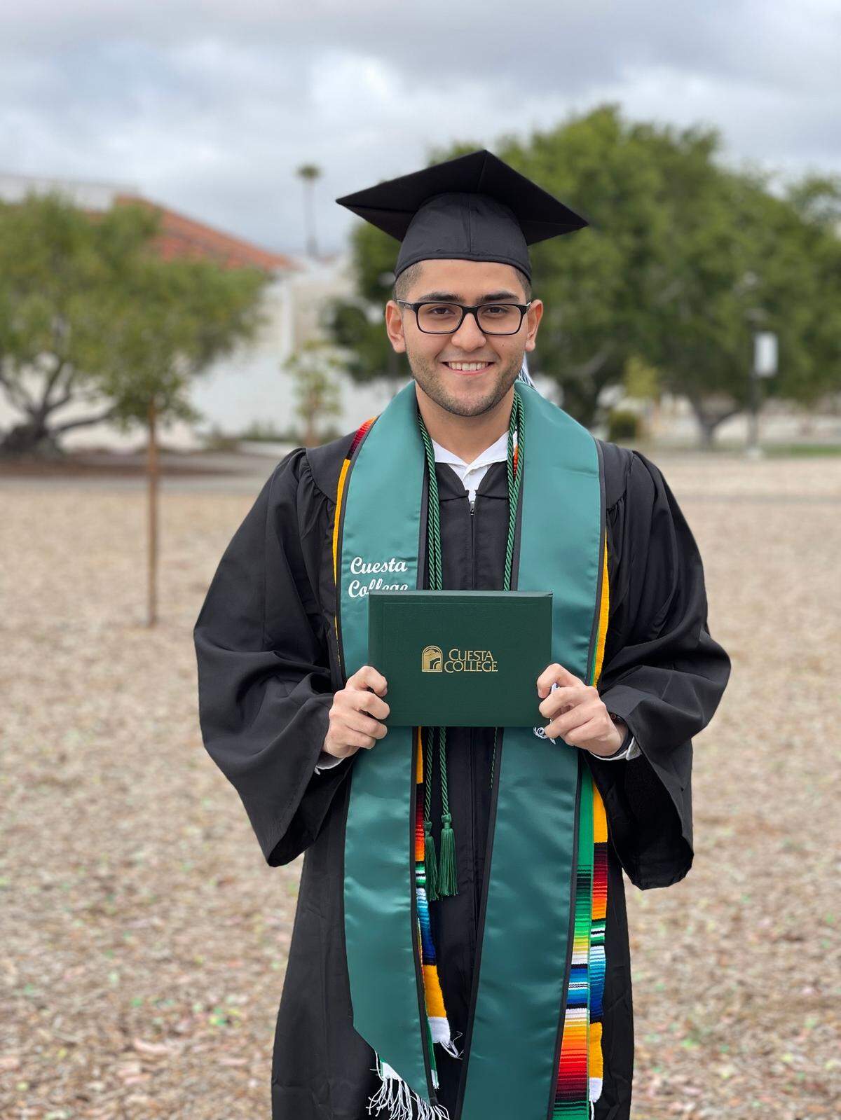 Daniel Moreno poses with his Cuesta College degree in business administration. Moreno graduated on May 21 with honors and plans to attend Cal Poly in the fall.