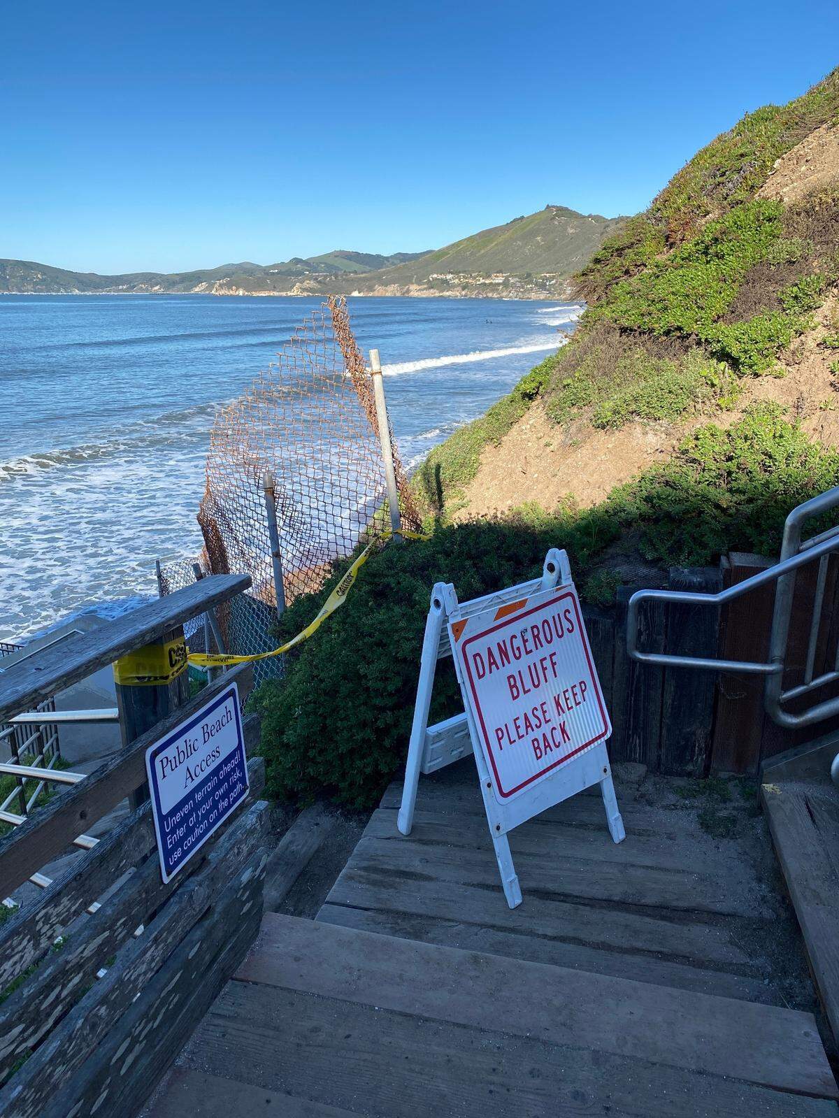 A sign closes access and notes the dangerous conditions on the stairs leading to the public beach beneath Ebb Tide Park in Pismo Beach.