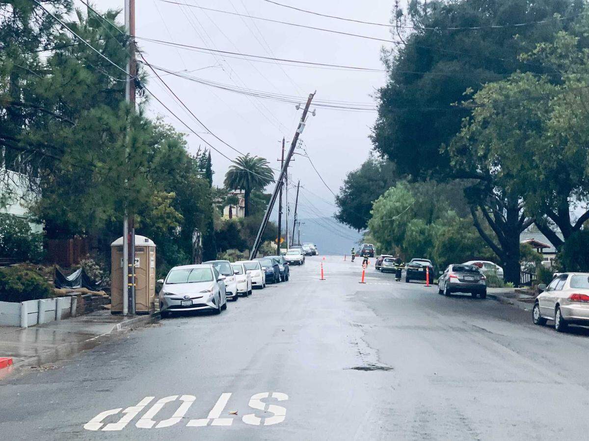 A broken power pole leans over the roadway on Ella Street in San Luis Obispo on Wednesday, Jan. 27, 2021. 