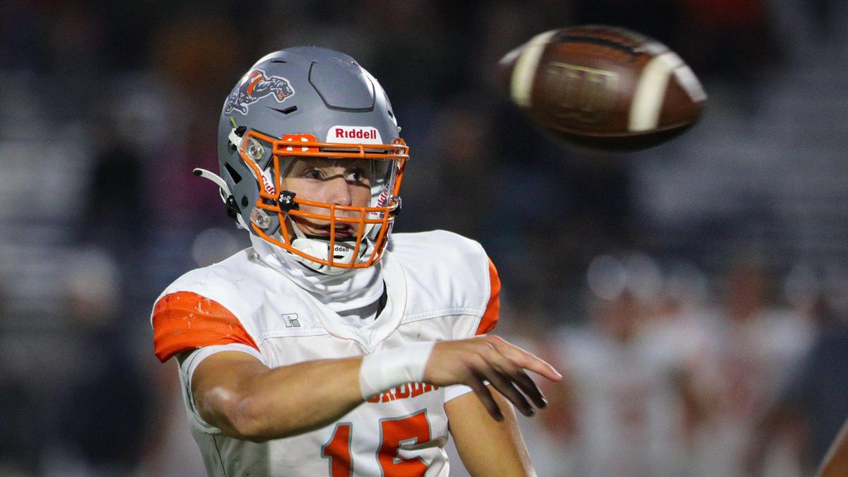 Kane Cooks makes a side arm pass under pressure from Dane Adler. Atascadero won 21-20 over San Luis Obispo. The Tigers hosted the Greyhounds in a high school football game Sept. 22, 2023.
