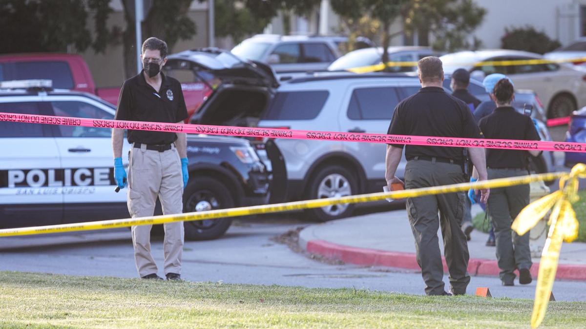 Police and sheriff’s deputies mark evidence on Margarita Avenue after a shooting Monday in San Luis Obispo. Two police officers and a suspect were shot during a warrant search. The suspect was confirmed dead, but the condition of the officers was not released initially.