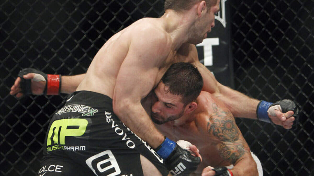 Former Cal Poly wrestler Chad Mendes, right, battles Nik Lentz during a UFC bout Dec. 14 in Sacramento. Mendes won by unanimous decision in the bout to run his winning streak to five.