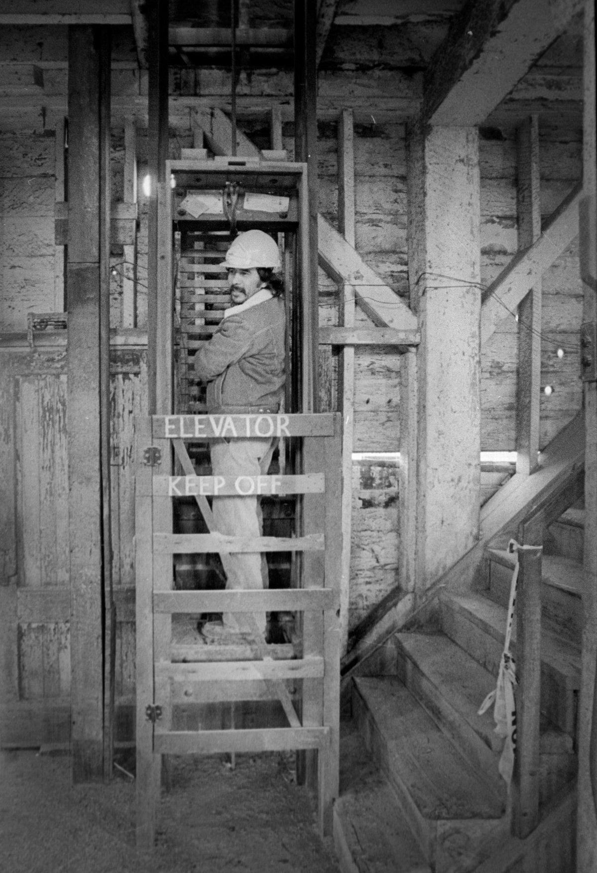 Salvador Nungary inspects the old rope drawn elevator for one. The Granary building in Paso Robles was getting ready for a new life after being built as a flour mill in 1891. The building was being cleared for renovation Jan. 6, 1887.