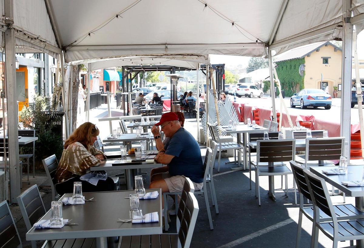 Diners eat outside in the parklet at La Cosecha Bar + Restaurant on 11th Street in Paso Robles. The city is ending its parklet program on Nov. 1, 2021, but will allow individual businesses to file for extensions. Carole MacDonal, who owns La Cosecha Bar, said that she will be filing for the extension. “People want to be out there and they insist on being out there,” MacDonal said. “They don’t want to be seated inside.”