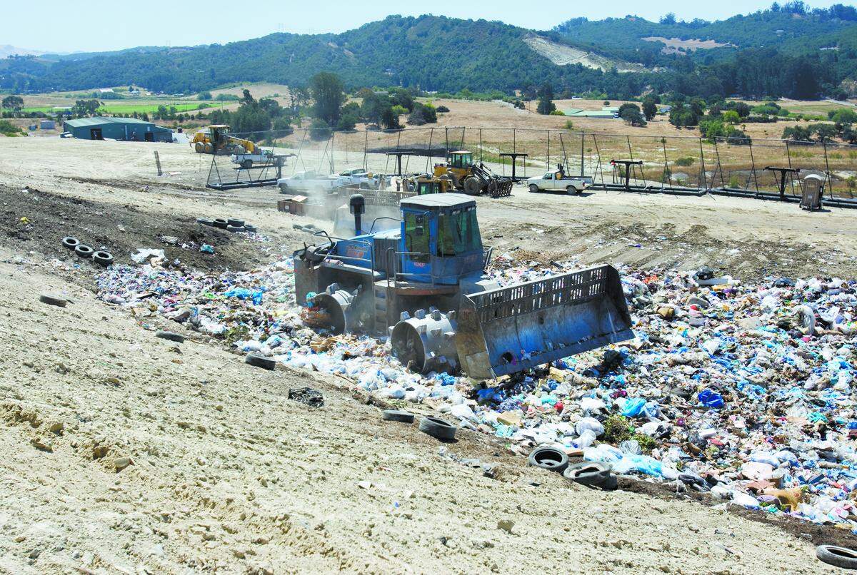 Heavy equipment shapes and compacts the garbage pile at Cold Canyon Landfill in San Luis Obispo.