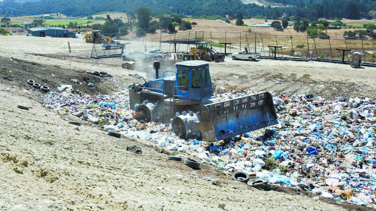 Heavy equipment compacts garbage pile at Cold Canyon Landfill in San Luis Obispo.