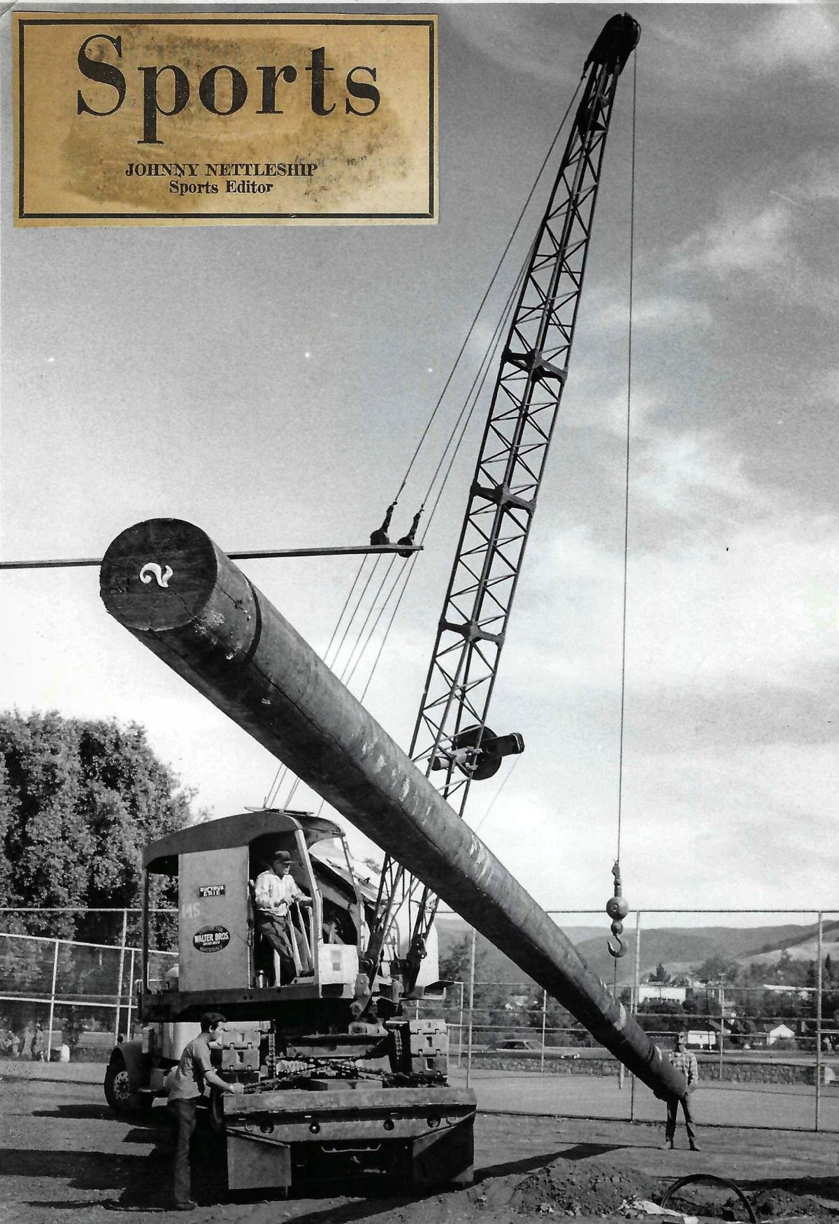 Charlie Walters of Walters Constructon operates the crane while V. Whinnery, left, and Buster Bello of PG&E watch the light pole being put in place. Published on Sept. 4, 1971. A Sports page logo was glued onto the photo during the design of the page.