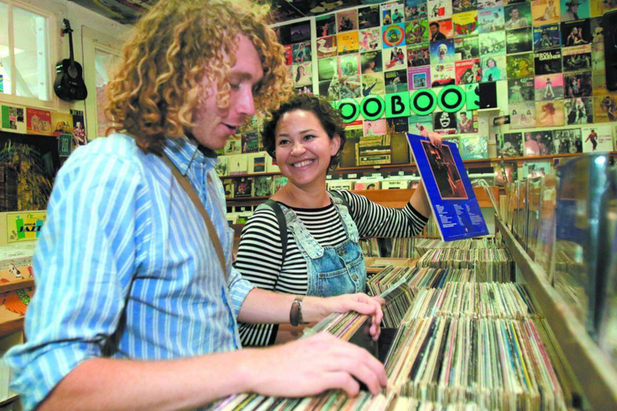 Arlo Elliott (left) and Ruby Allen, both of San Luis Obispo, search the selection of vinyl records in Boo Boo Records in San Luis Obispo. Elliott said LPs make him “appreciate the music more because ... you have to invest time, sit down and take in the music.”