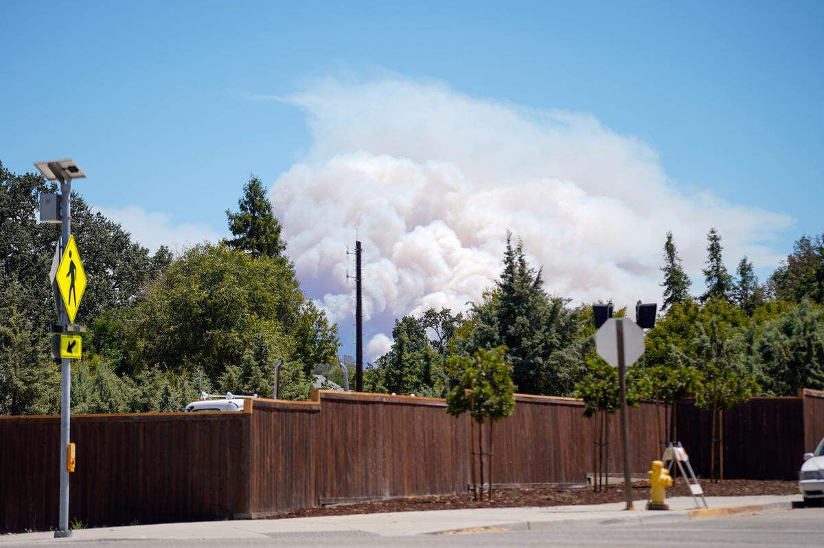 The Gifford Fire looms in the distance, seen here from downtown Santa Margarita on Wednesday, Aug. 13, 2025.
