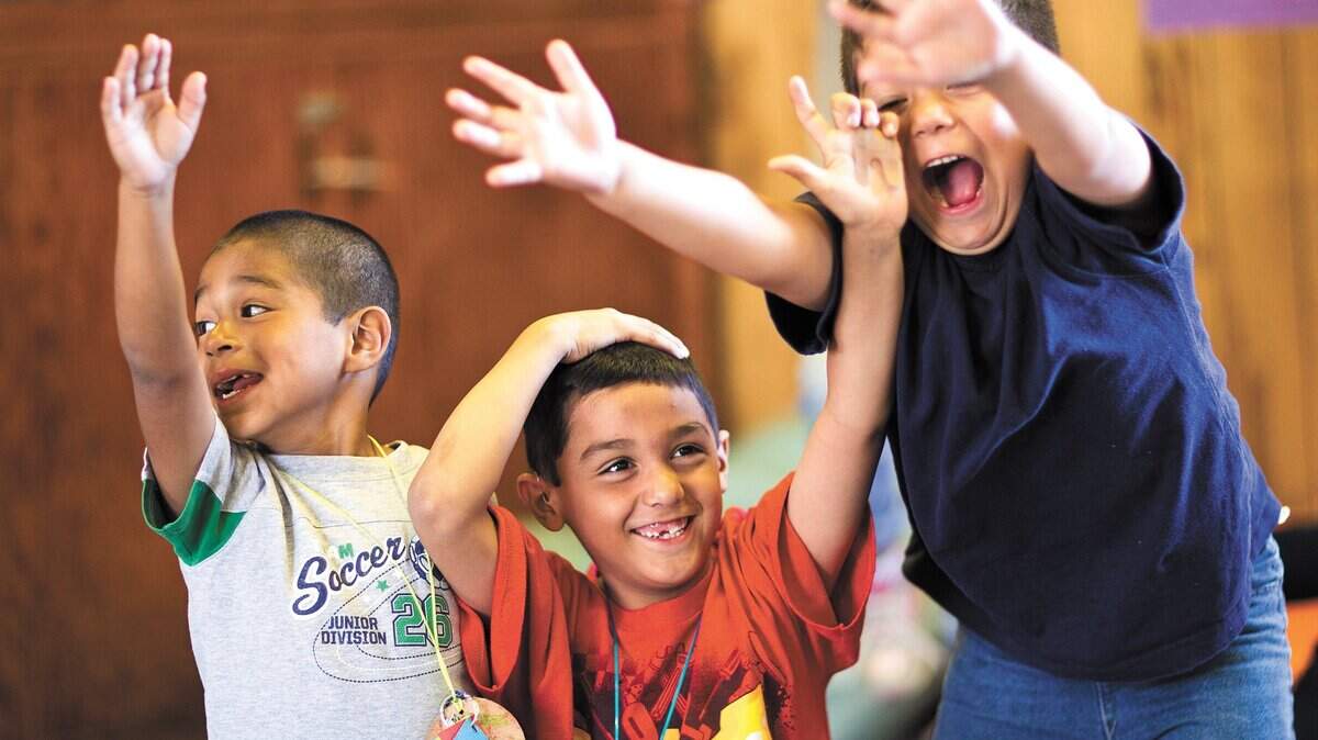 Three kids known by their camp names, from left, Dolphin, Mellow Rabbit and Brave Cat, compete to answer a question during an activity at Camp Hapitok in 2010.