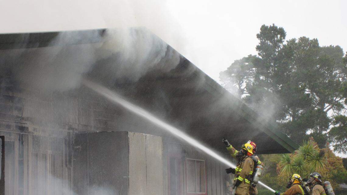 Crews fight a fire in the old, enclosed swimming pool building at Cambria Pines Lodge on Friday afternoon.