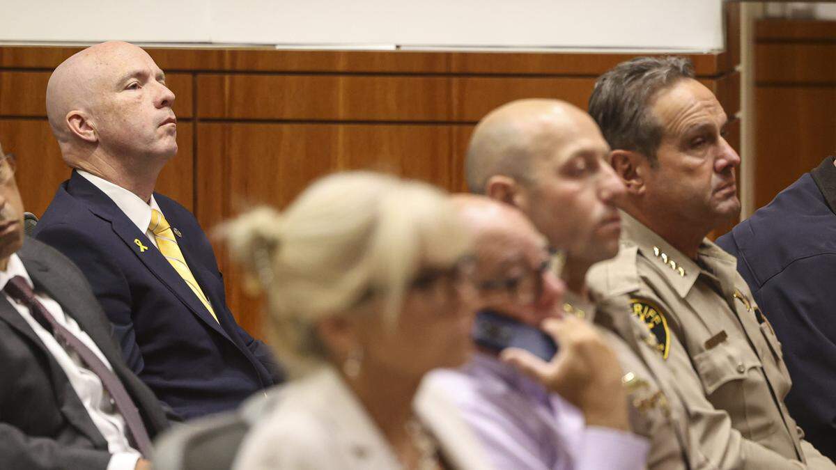 District Attorney Dan Dow, left, and Sheriff Ian Parkinson were among the audience. The San Luis Obispo County Board of Supervisors took public comment and official presentations on a controversial federal grant, seen here on Aug. 5, 2025.