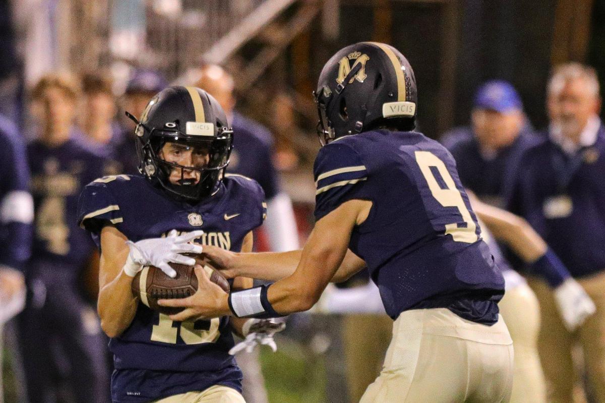 Luke Terry takes the ball from Colby White. Mission Prep defeated Paso Robles 28-7 in a Mountain League football game on Sept. 30, 2022, in San Luis Obispo.