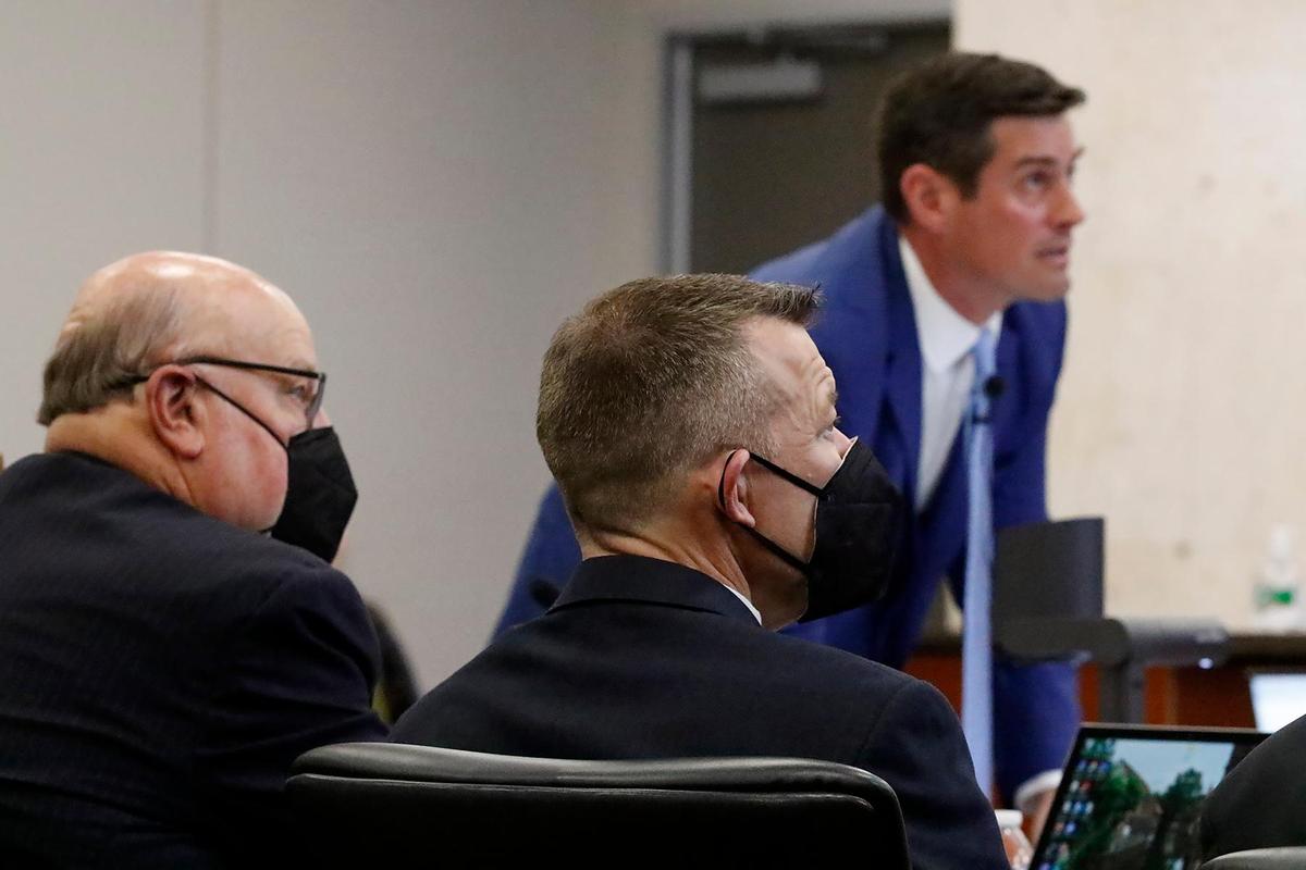 Prosecutor Chris Puervelle puts a slide on a projection screen as defense attorney Paul Sanger, left, and defendant Paul Flores look on in Monterey County Superior Court in Salinas on Monday, Sept. 19, 2022, during the Kristin Smart murder trial.