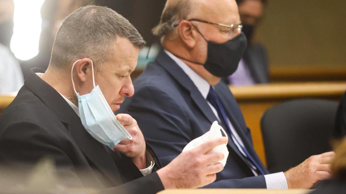 Paul Flores puts on a new N95 mask in San Luis Obispo Superior Court on Tuesday, Aug. 3, 2021, during a preliminary hearing. He is accused of the murder of Cal Poly student Kristin Smart. Robert Sanger, one of his attorneys, is at right.