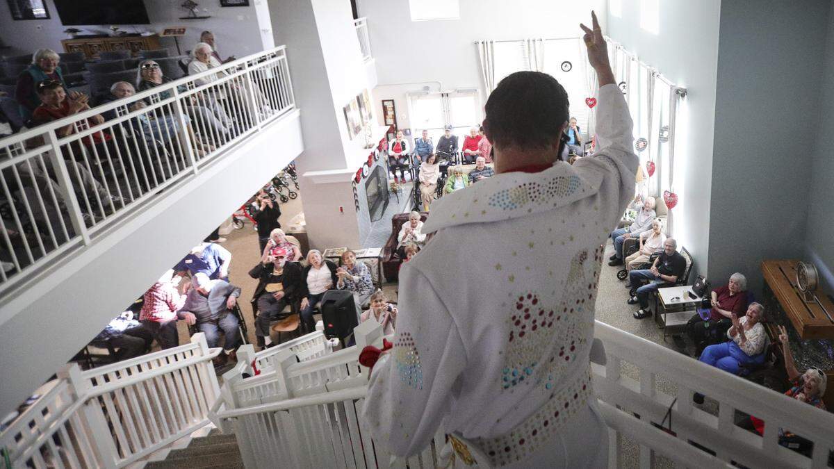 Elvis comes down the stairs at Creston Village, an assisted living community in Paso Robles to celebrate Valentine's Day on Feb. 12, 2026. The King sang some of his hits and passed out red roses to residents. He has a remarkable resemblance to Adam Bramwell, the Executive Director of the facility.