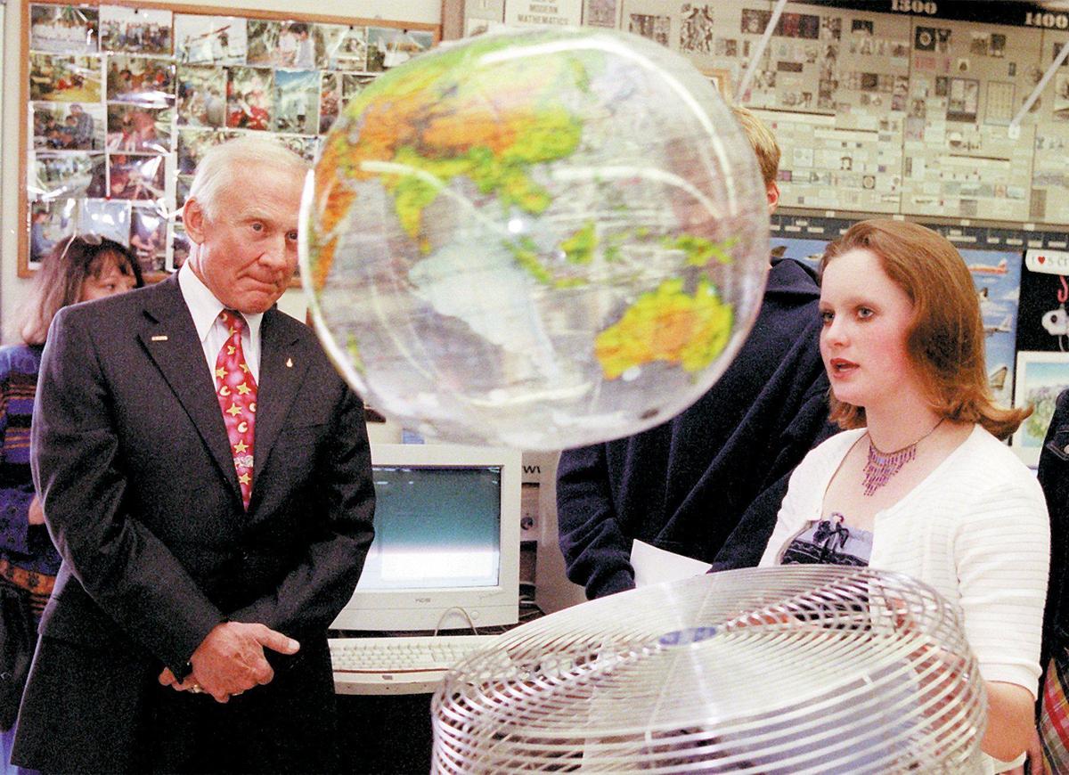 Brittney Clark, 16, demonstrates one of the experiments sophomore science students work with at Arroyo Grande High School on April 6, 2001. This demonstrates the effect of wind on a sphere. Astronaut Buzz Aldrin has seen the earth from this point of view from a seat in Apollo 11 on its way to the first moon landing.