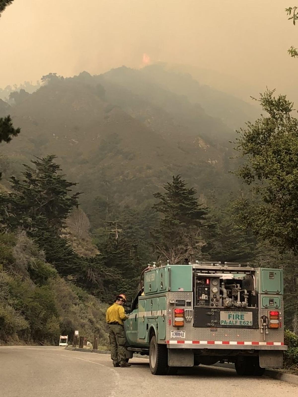 A firefighter from Pennsylvania monitors the Dolan Fire Sunday, Aug. 23.