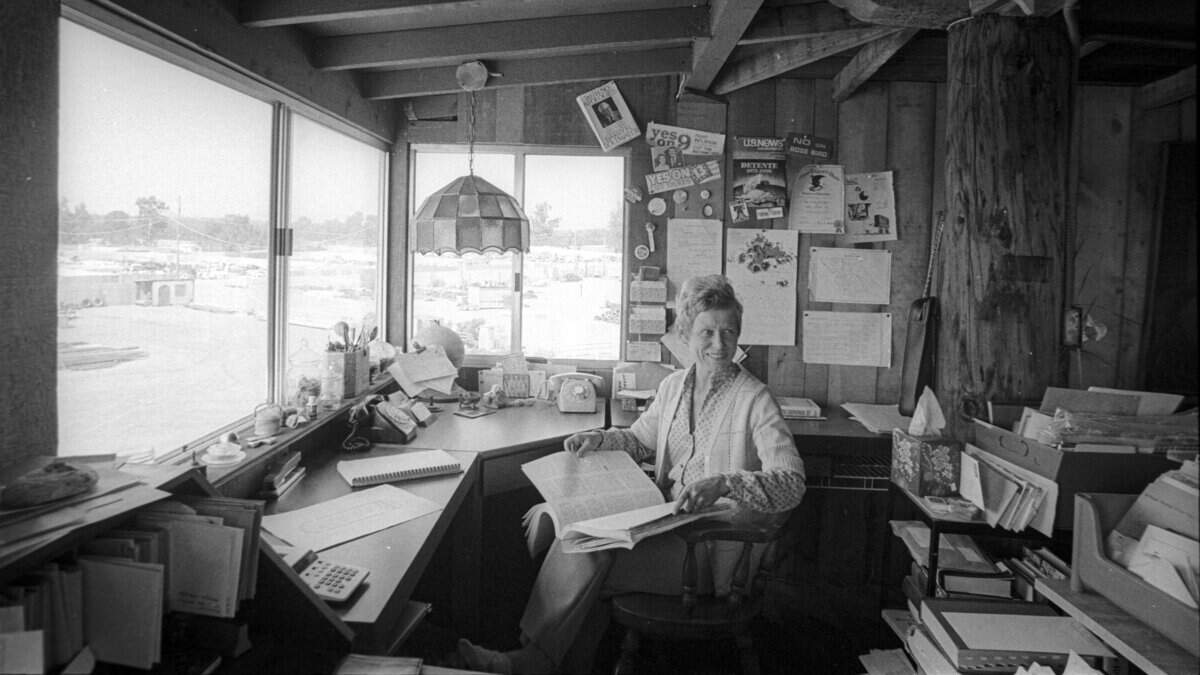 Ruth Brackett sits with a county planning document at a desk in her Nipomo Mesa home on July 18, 1980. Her window overlooks the salvage yard that led to her tangles with the local government.