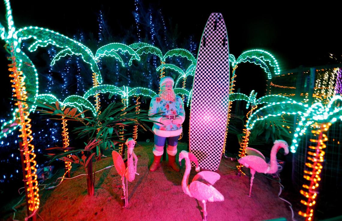 A surfing Santa Claus display is among the quirkier decorations at the Cambria Christmas Market on Wednesday, Dec. 14, 2022.