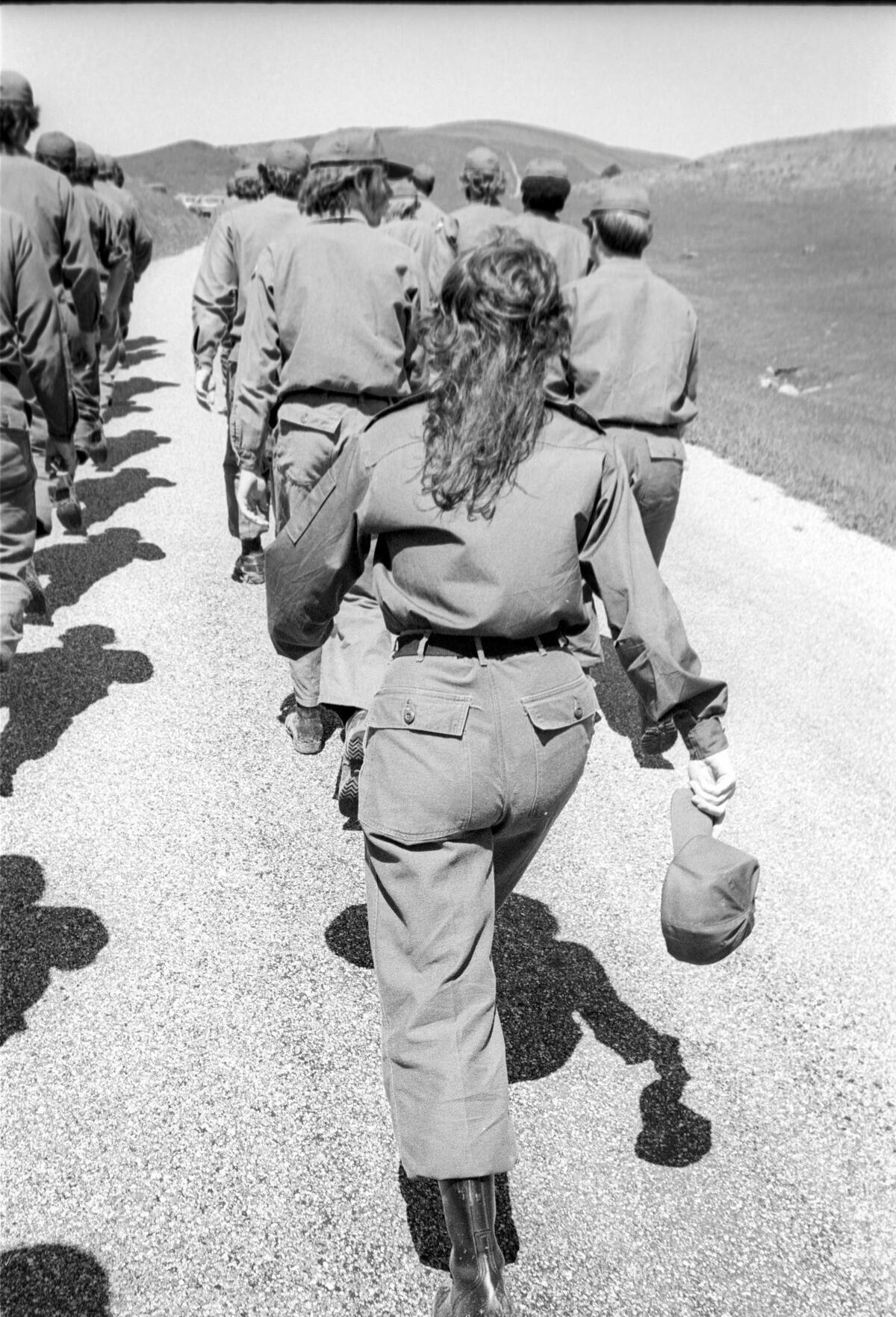 Tori Cortner falls in at the end of a column of marching cadets. Cal Poly ROTC cadets train on April 6, 1974