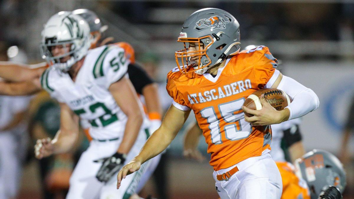 Kane Cooks carries the ball as the Atascadero Greyhounds beat the Templeton Eagles 27-21. Walker Craven (52) of Templeton chases in the background.