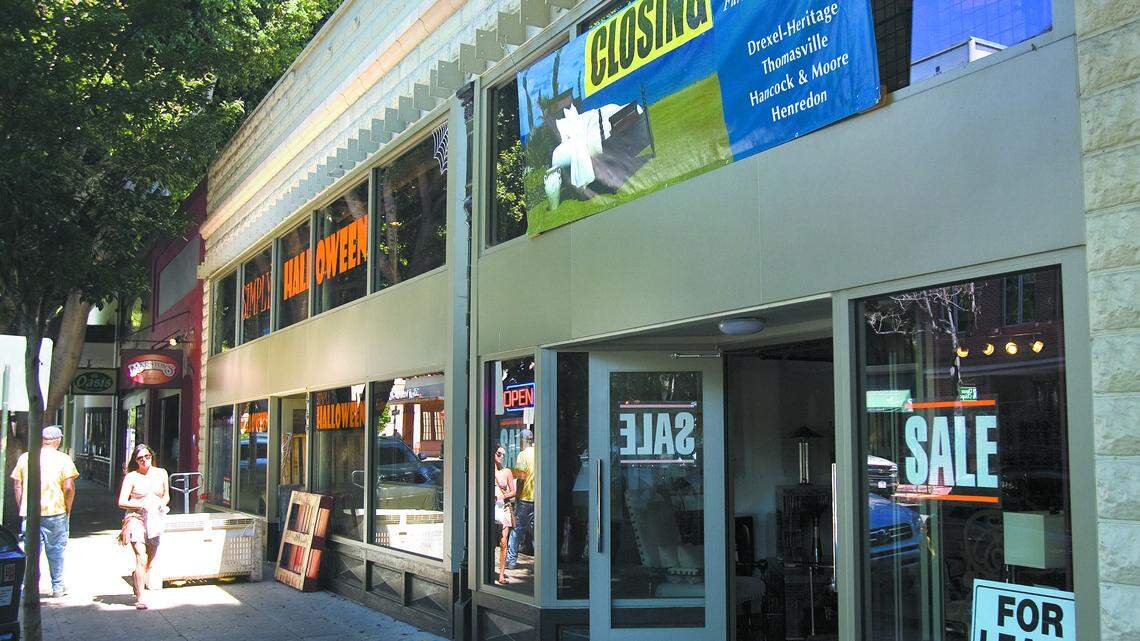 Signs announce the closing of Davidson's Furniture, which has been a fixture on Higuera Street for decades.