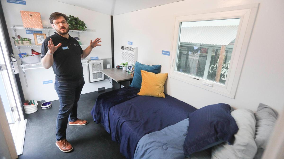 Ted Sweeney, community development manager with Pallet Shelter shows an S2 ensuite, it is a 120 square foot unit with a 3/4 bathroom. The other unit shown was smaller, 70 sq. ft. with no bath.