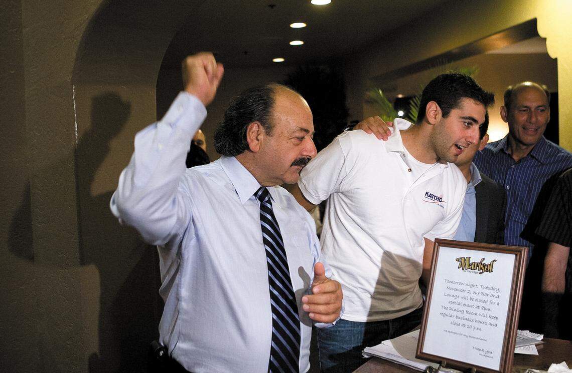 Katcho Achadjian celebrates early returns with son Hratch Achadjian (in white shirt) at a party held at the Cliffs in Shell Beach.