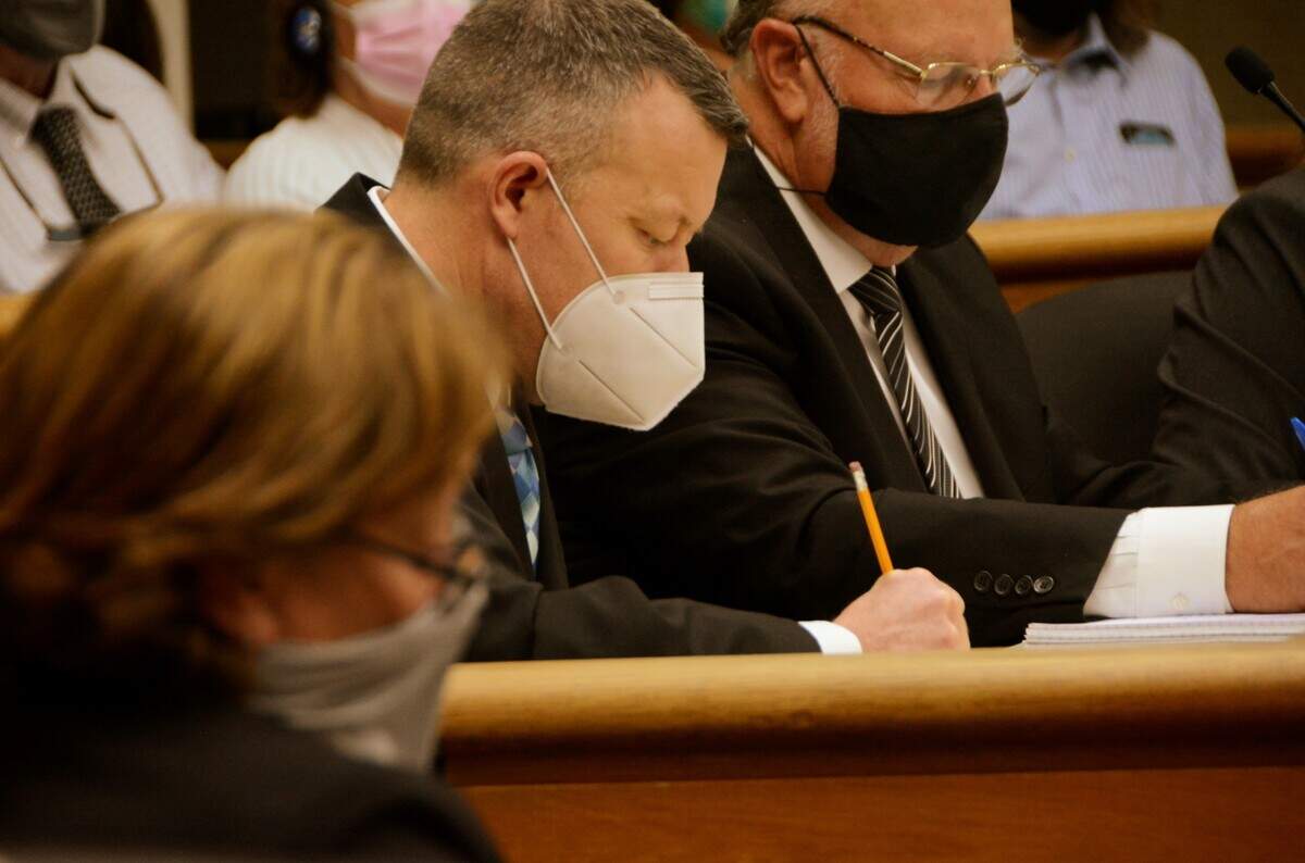 Paul Flores, accused in the 1996 disappearance of Cal Poly freshman Kristin Smart, takes notes during an Aug. 4, 2021, San Luis Obispo Superior Court preliminary hearing. At right is defense attorney Robert Sanger.