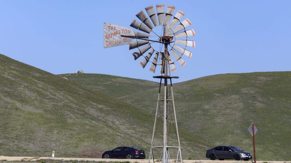 A windmill spins in the spring breeze north of Cayucos near Highway 1.