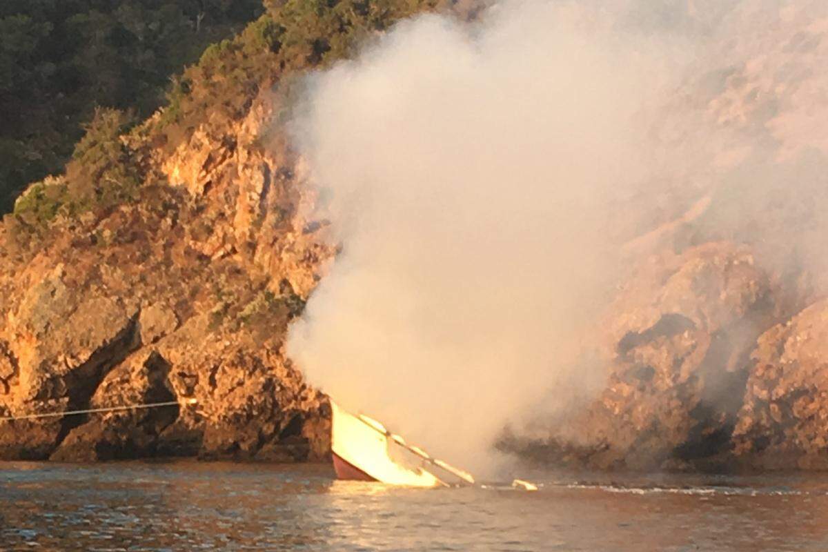A debris field forms behind the Conception as the dive boat sinks in Platts Harbor on the north side of Santa Cruz Island. Once it started to submerge, the boat sank within five minutes, its bow the last to disappear.