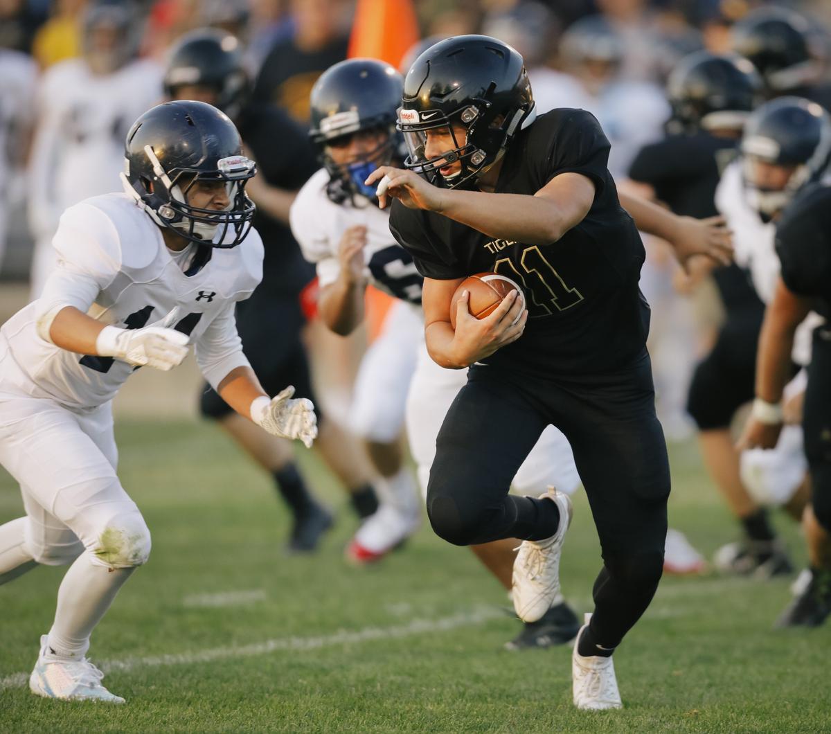 San Luis Obispo High School’s Emilio Corona carries the ball in a non-conference game Friday against Arroyo Grande.