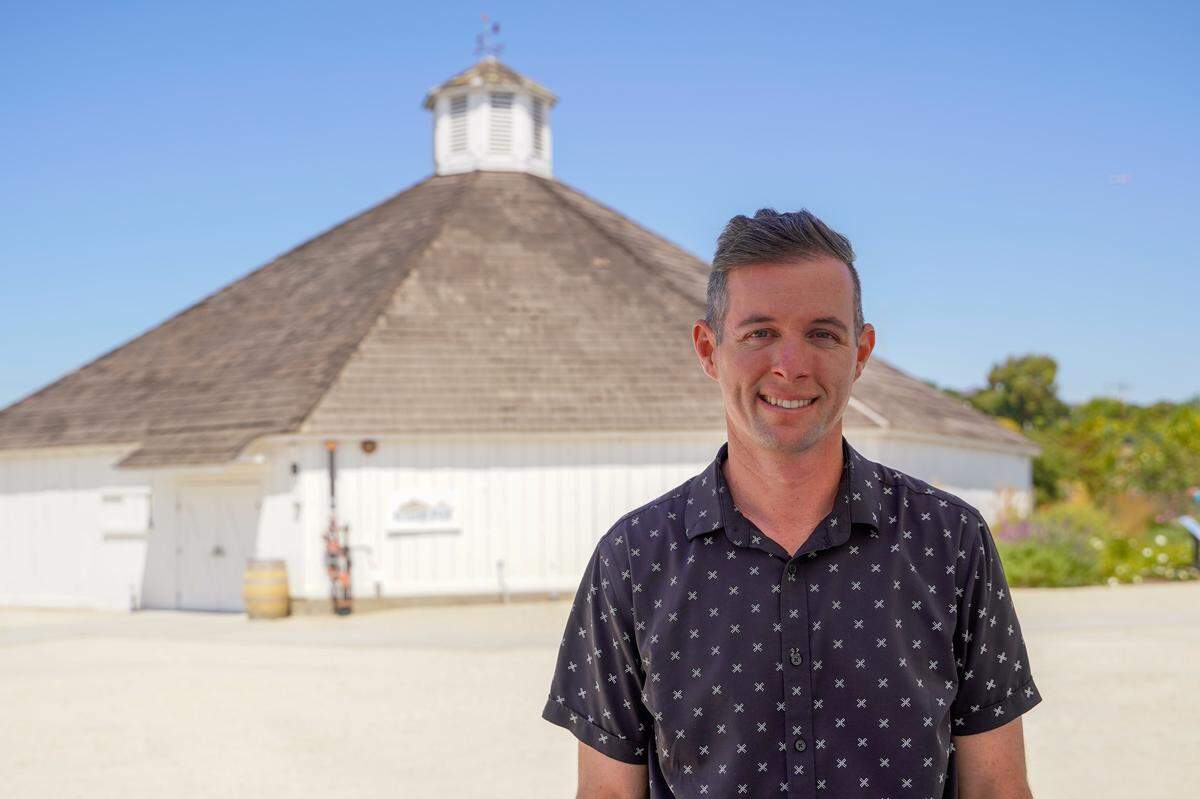 Antioch Church pastor Ben Collins stands in front of the Octagon Barn following a church service on Sunday, Aug. 24, 2025. Antioch Church grew from a Bible study group in late 2024 into a congregation that meets at the Octagon Barn.
