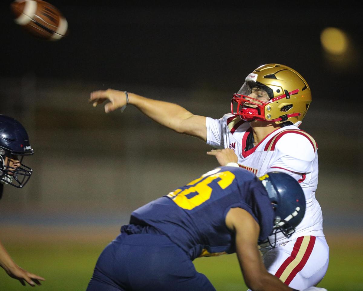 The Centennial quarterback gets a throw away under pressure from Devon Mottinger in Arroyo Grande’s 39-7 loss on Aug. 26, 2022.