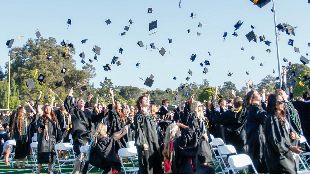 San Luis Obispo High School seniors throw their graduation caps into the air at the end of commencement ceremonies at Holt Field on Friday, June 5, 2026. 374 seniors received their diplomas.