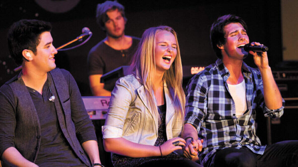 Amy Boggan, 14, is serenaded by Big Time Rush’s James Maslow, right, and Carlos Pena Jr. at the Nick Rocks Your School concert on Wednesday.
Photo Jayson Mellom 11-16-11