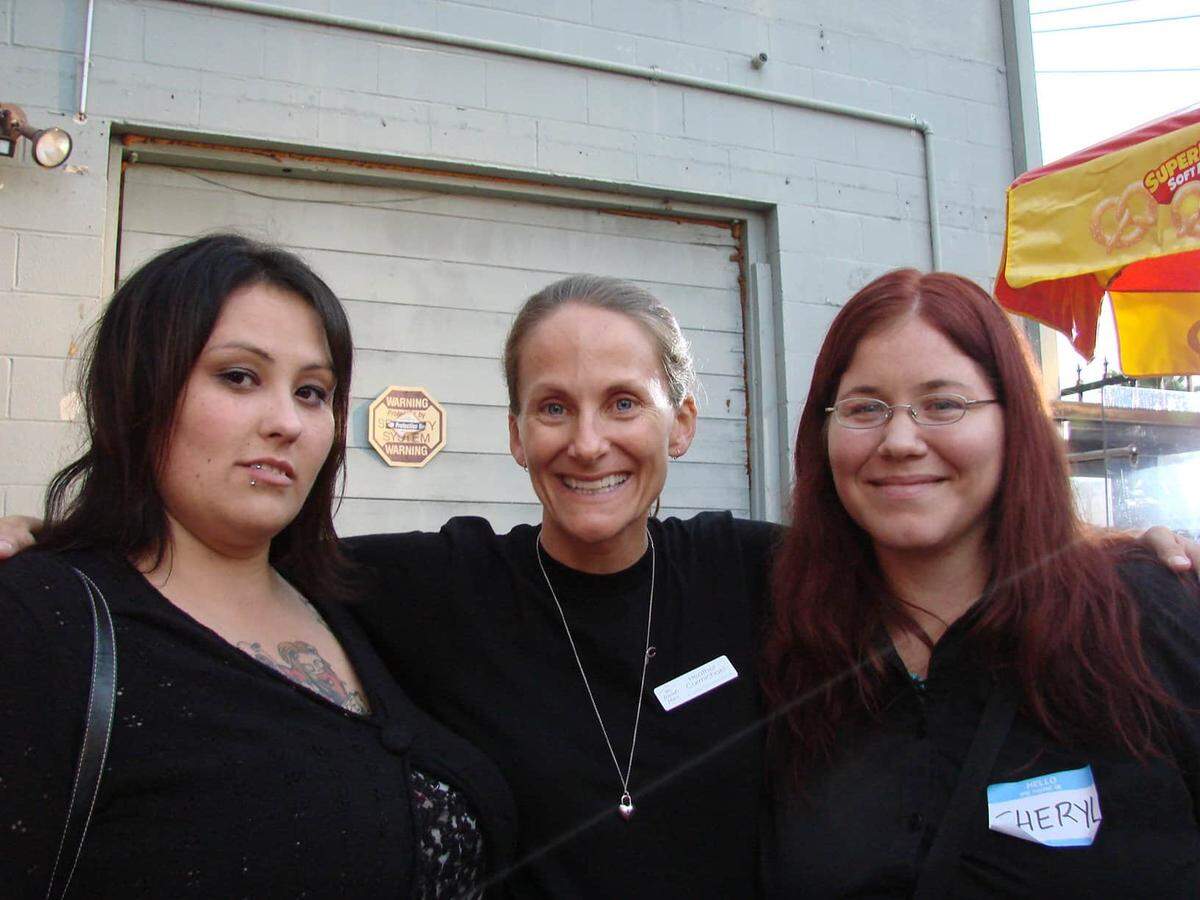Michelle Mansker, left, and her longtime best friend Sheryl Recinos, right, pose for a photo with Mansker’s former case manager from one of the drop-in centers in Hollywood.