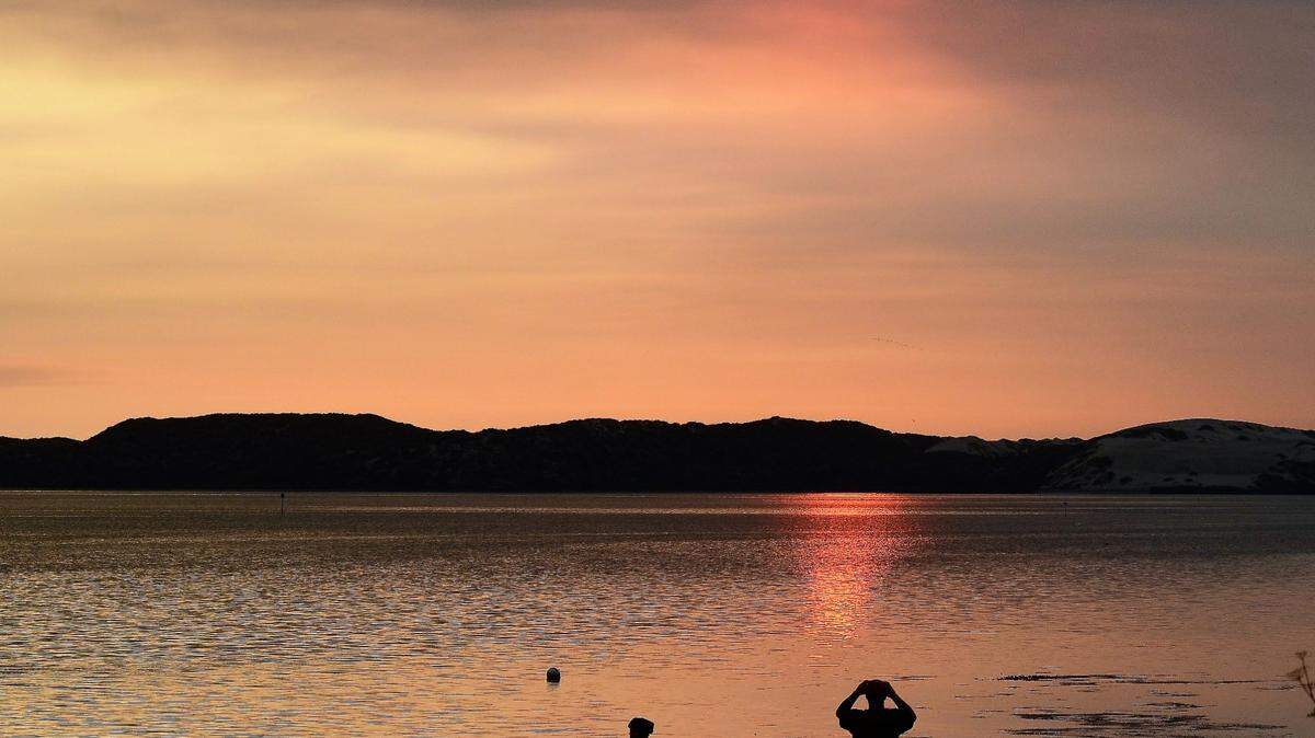 The sun sets in Morro Bay.